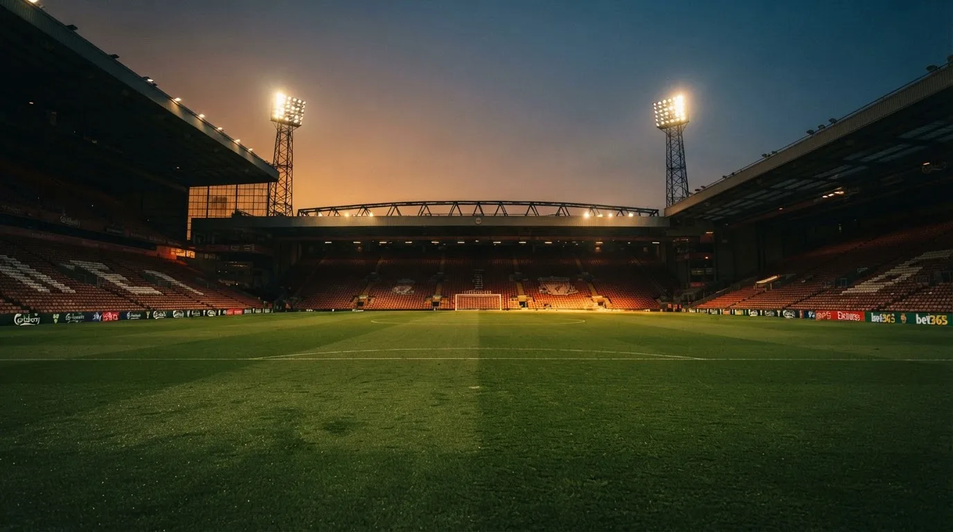 An empty football stadium with floodlight masts at dusk